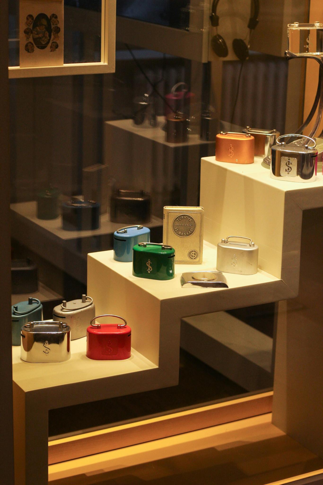 Elegant retail display showcasing luxury watches on stacked shelves in a storefront window.